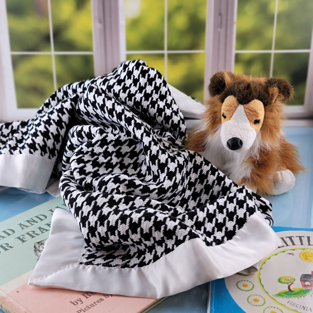 Houndstooth blanket with stuffed Collie and books