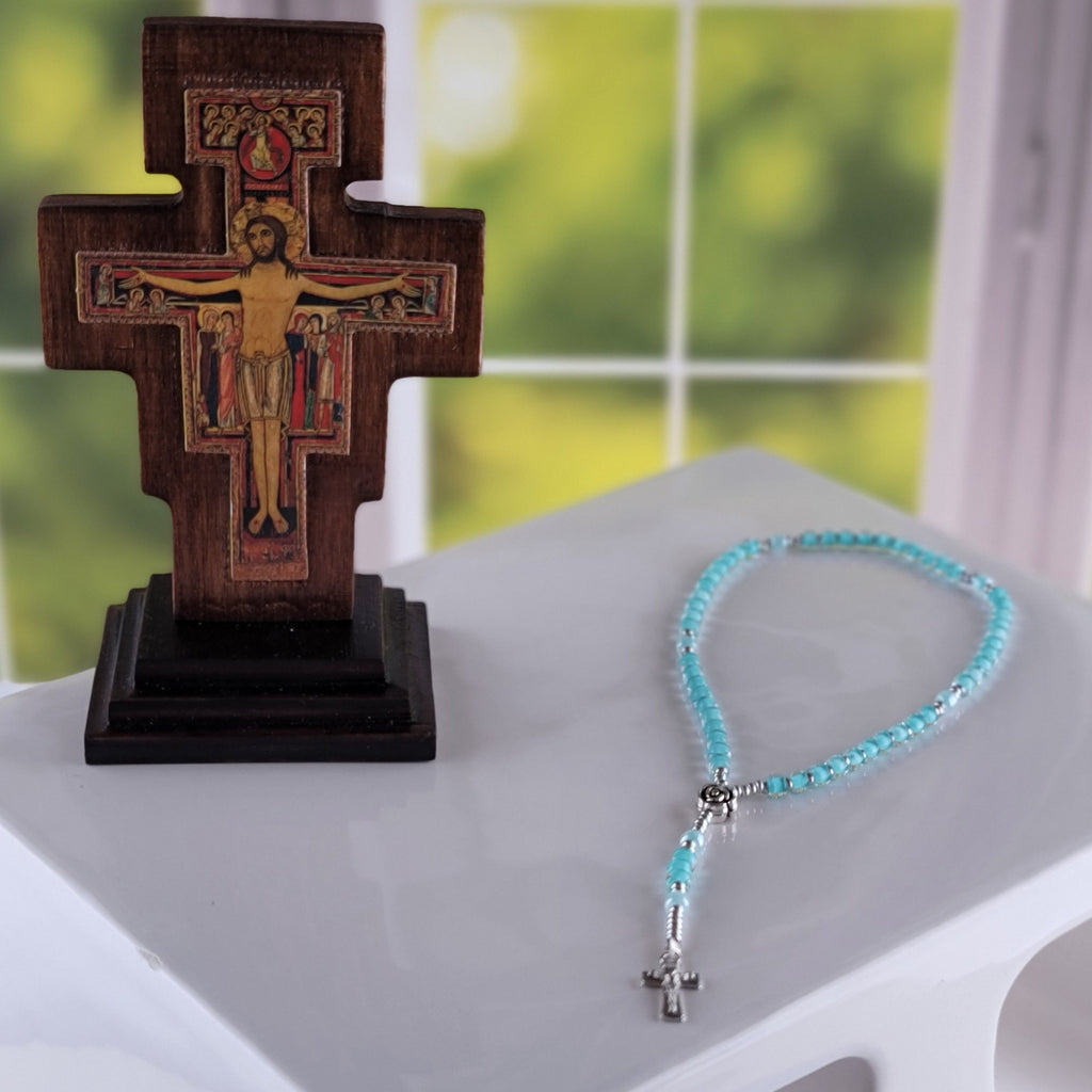 Pool rosary near crucifix