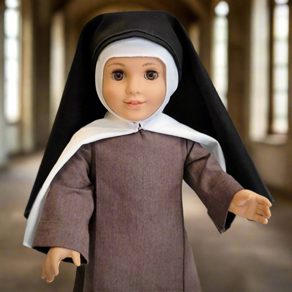 close up of 18-inch doll dressed as St. Therese of Lisieux with tunic, toque, scapular, mantle, and veil 